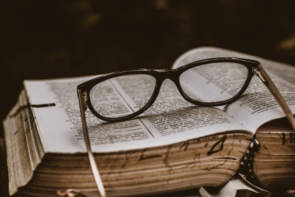 black-spectacles-otop-an-open-book